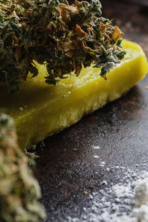 rustic cannabis butter and medical marijuana bud and flour on old rust metal dripping pan. old wooden background. vertical. close-up.の写真素材