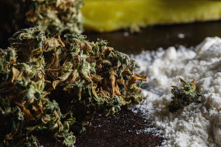 rustic cannabis butter and medical marijuana bud and flour on old rust metal dripping pan. old wooden background. horizontal orientation. close-up.の写真素材