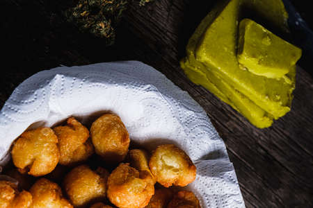 churros balls spanish donuts from medical cannabis butter, sugar, flour, egg. marijuana buds. medical cannabis butter. On a rusty baking sheet. horizontal orientation. top viewの写真素材