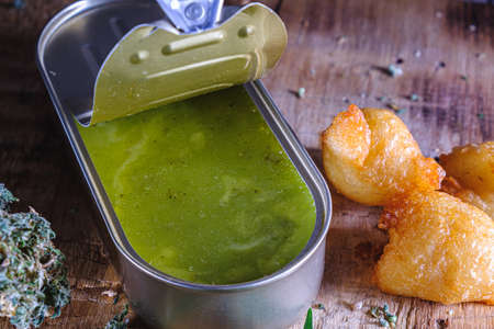 balls donuts from medical cannabis butter, sugar, flour, egg. marijuana buds. medical cannabis butter in a open tin can. hemp leaves. On a old wooden. horizontal orientation.の写真素材
