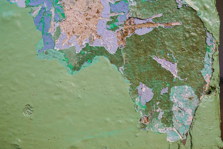 Old dirty painted wall. Several layers of peeling paint. background texture. Horizontal orientationの写真素材