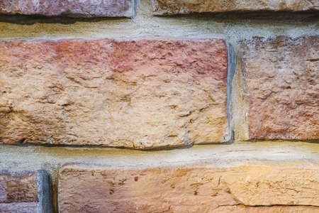 stylized old brickwork geometric pattern uneven textured beautiful warm stone surface. decor....