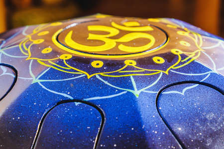 colors steel Tongue Drum, Vadjraghanta, Tank Drum for Sound Waves Therapy and Meditation, Healing. Close-up modern musical instrument Hand pan or metal tongue drumon highly artistic productの写真素材