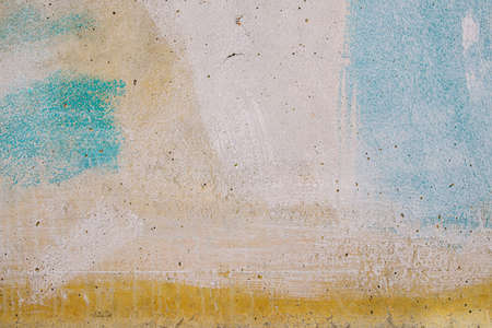 Old dirty concrete surface painted with rough polishes in different colors. background texture. Horizontal orientationの写真素材