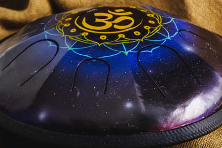 colors steel Tongue Drum, Vadjraghanta, Tank Drum for Sound Waves Therapy and Meditation, Healing. Close-up modern musical instrument Hand pan or metal tongue drumon highly artistic productの写真素材