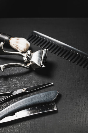 vintage barber tools. dangerous razor, hairdressing scissors, old manual clipper, combs, shaving brush. black monochromeの写真素材