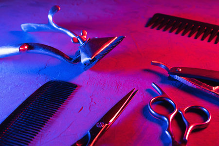 red and blue psychedelia cinematic aesthetics. on surface are old barber tools. horizontalの写真素材