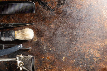 On a rusty surface are old hairdresser tools. manual clipper, comb, razor, shaving brush. rustic. horizontal. top view. flat ley. copy space.の写真素材