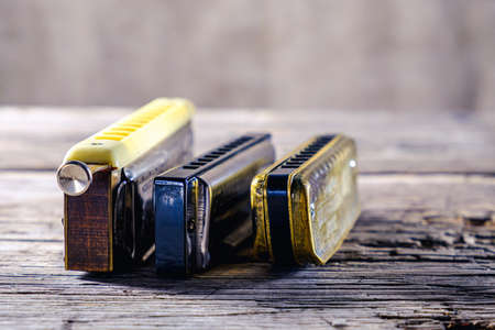 Musical instruments vintage harmonics diatonic and chromatic on old wooden desk. world music day. Horizontal orientation.の写真素材