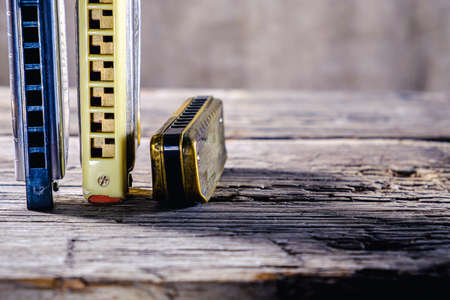 Musical instruments vintage harmonics diatonic and chromatic on old wooden desk. world music day. Horizontal orientation.の写真素材