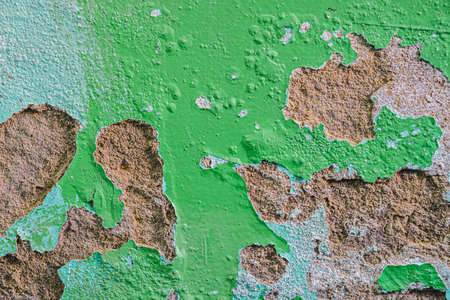 Old dirty painted wall. Several layers of peeling paint. background texture. Horizontal orientationの写真素材