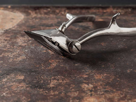 vintage barber tools. Vintage manual clipper on a rusty surface.