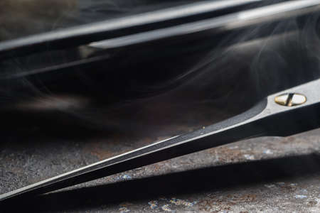 On a rusty surface are old hairdresser tools. hairdressing scissors, razor, close up. rustic....