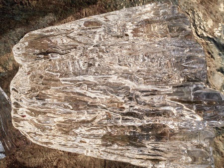 Natural crystal clear melting ice cubes on rock surface background. Verticalの写真素材