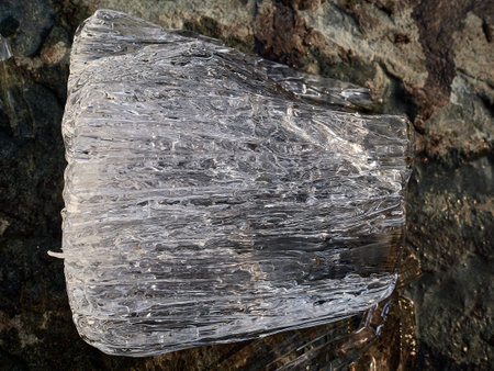 Natural crystal clear melting ice cubes on rock surface background.の写真素材