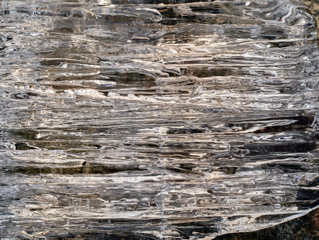 Natural crystal clear melting ice cubes on rock background.の写真素材