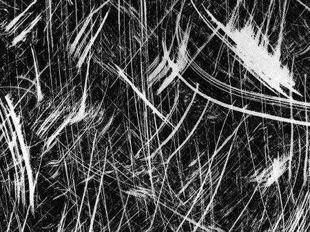 Intricate patterns emerge in this abstract representation of a surface marked by swift, chaotic lines. The interplay of black and white creates a striking visual effect.の写真素材