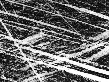 Unique black and white patterns emerge from the interplay of intersecting lines on a textured surface, creating a striking abstract composition full of energy and movement.の写真素材