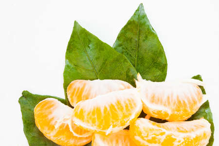 Fresh tangerine with leaves and segments の写真素材