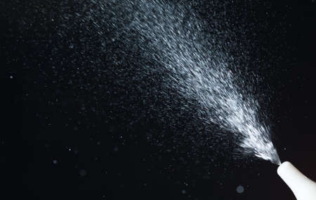 Nasal spray while spraying over black backgroundの写真素材