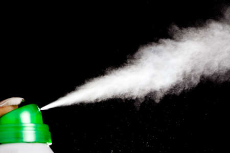 spray aerosol on black background