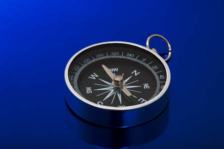 a chrome compass over blueの写真素材