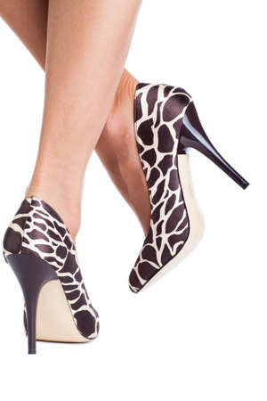 Giraffe print shoes on lady isolated on whiteの写真素材