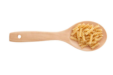 raw pasta and wooden spoon isolated on white backgroundの写真素材