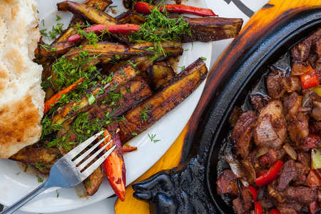 meat on a roasting pan and pitaの写真素材