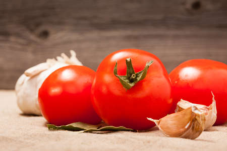 Fresh tomatoes on a  background  wooden boardsの写真素材