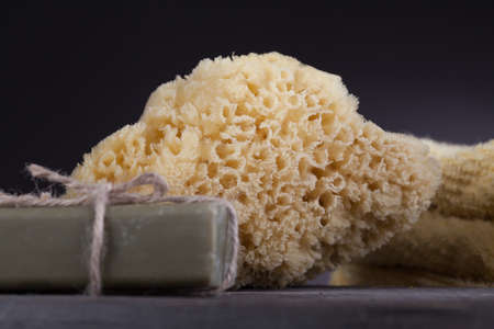 Soap, towel and a sponge on wooden boardの写真素材