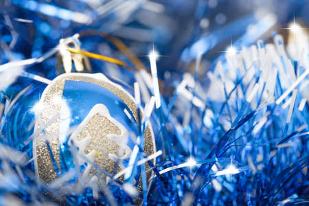 Blue and silver xmas ornaments on bright holiday background の写真素材