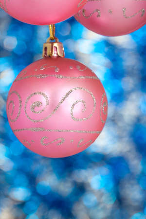 Three pink New Year balls against blue shine の写真素材