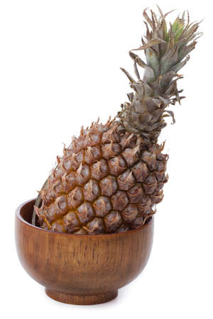 pineapple in wooden bowlの写真素材