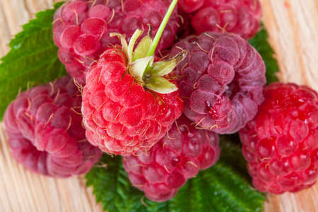 Ripe raspberries on the wooden boardの写真素材