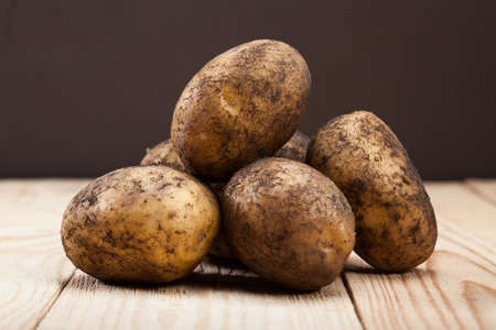 Potato on wooden deskの写真素材