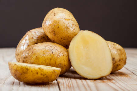 Potato on wooden deskの写真素材