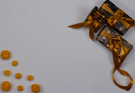 In anticipation of the holiday of Christmas, a greeting card with a simple white background is suitable. In the corners are Christmas gifts and balls. Concept for Christmas cards and backgrounds.の写真素材