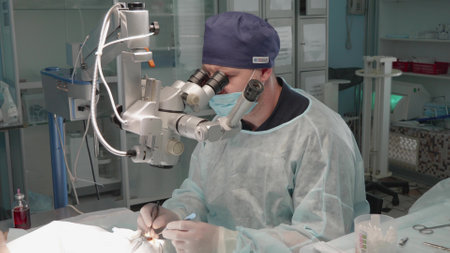 The animal is operated on the eye under an ophthalmic microscope by a veterinary surgeon. The ophthalmologist is focused on the operation. The concept of veterinary ophthalmology.の写真素材