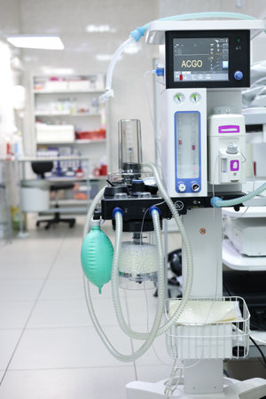 The anesthesia machine stands in an empty surgery, ready to go. Equipment for artificial lung ventilation and anesthesia without people. The concept of equipment in surgery.の写真素材