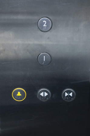 Close-up of the button panel in the elevator. Buttons in the elevator with floor numbers on a metal panel. Empty elevator with button panel and floor numbers.の写真素材