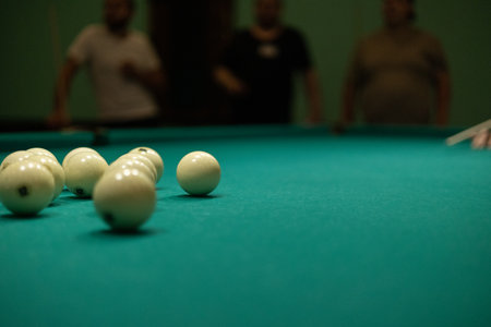 A group of people gathered in the billiard room to play and have fun. A group of friends plays billiards. People relax and play billiards.の写真素材