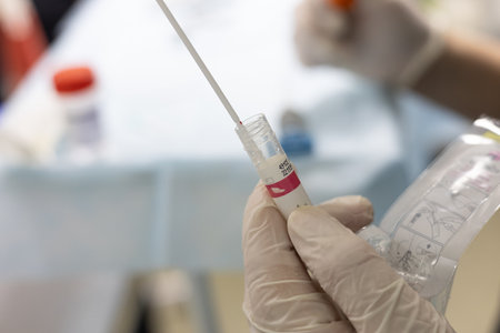 The doctor removes a piece of tissue from the endoscopic biopsy forceps and places it in a jar to be...
