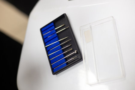 Veterinary instruments set featuring organized burs in a black box with blue foam, placed on a white table within a clinic or hospital environment, ready for animal care and treatment.の写真素材