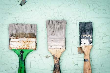 Brush covered with paint on a wooden backgroundの写真素材