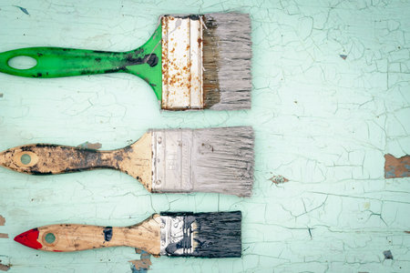 Brush covered with paint on a wooden backgroundの写真素材