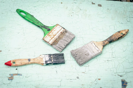 Brush covered with paint on a wooden backgroundの写真素材