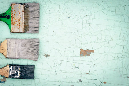 Brush covered with paint on a wooden backgroundの写真素材