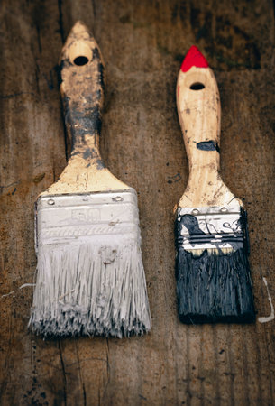 Brush covered with paint on a wooden backgroundの写真素材