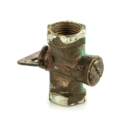 Old metal faucet on white backgroundの写真素材